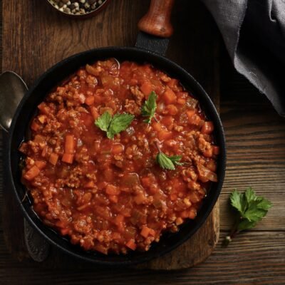 Bolognese sauce in pan top view